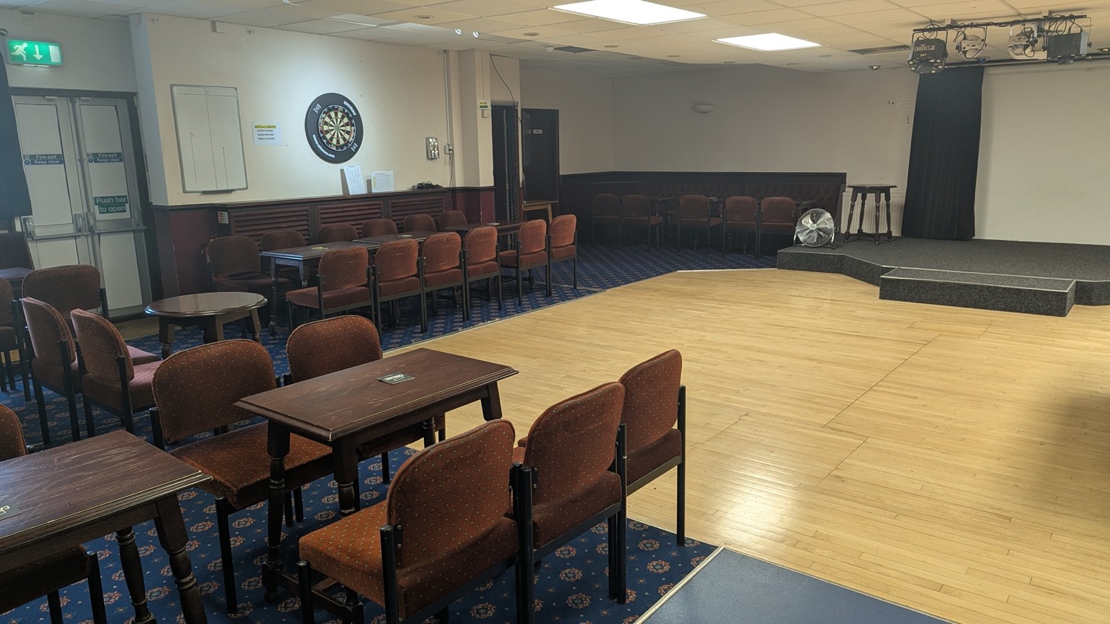 Function room with stage, dance floor and disco lighting